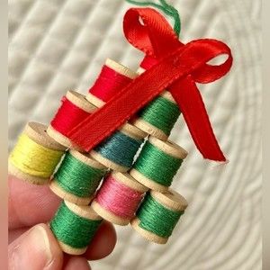Vintage handmade spools of thread ornament. Multi-colored thread spools.